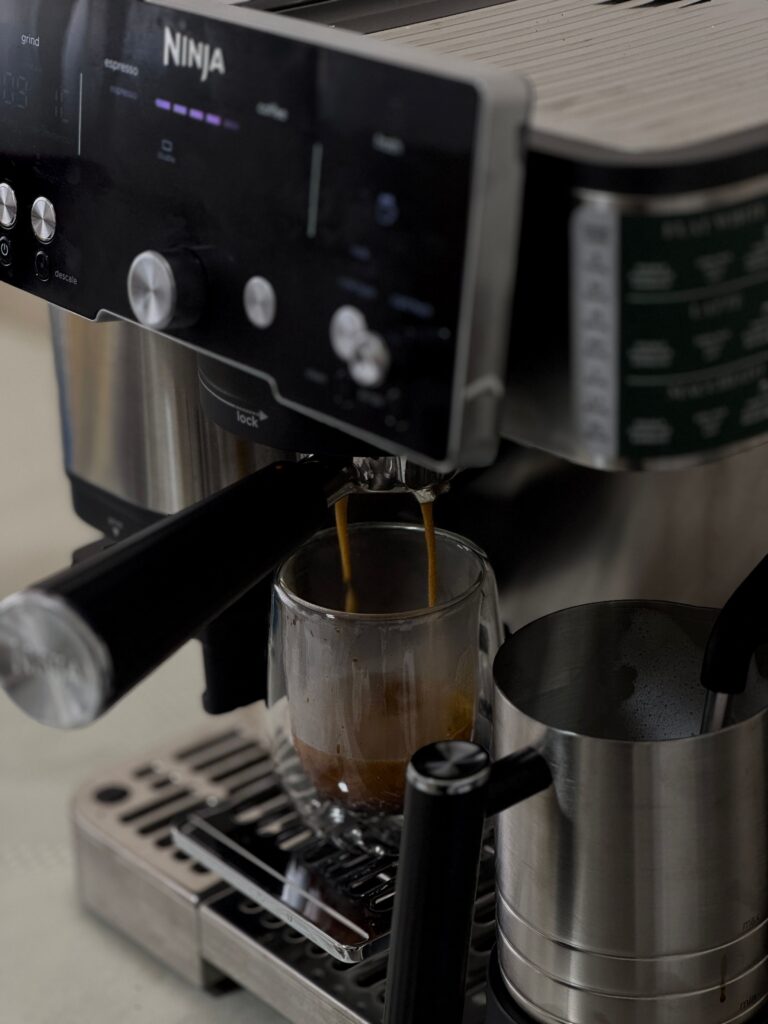 Compact espresso machine brewing coffee in a modern kitchen