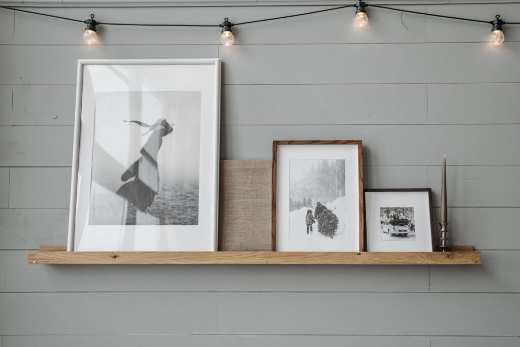 Framed pictures displayed on a shelf