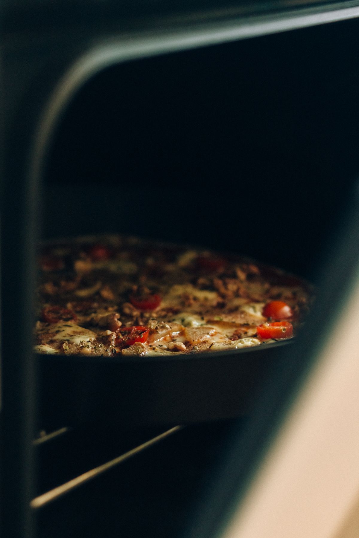 Pizza baking inside a home oven