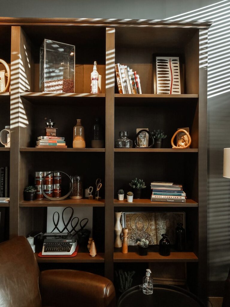 Bookcase with books and decorative objects in a room