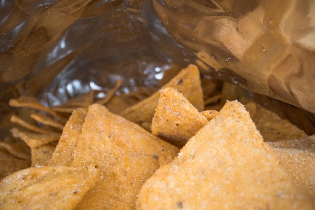 Tortilla chips in an open snack bag