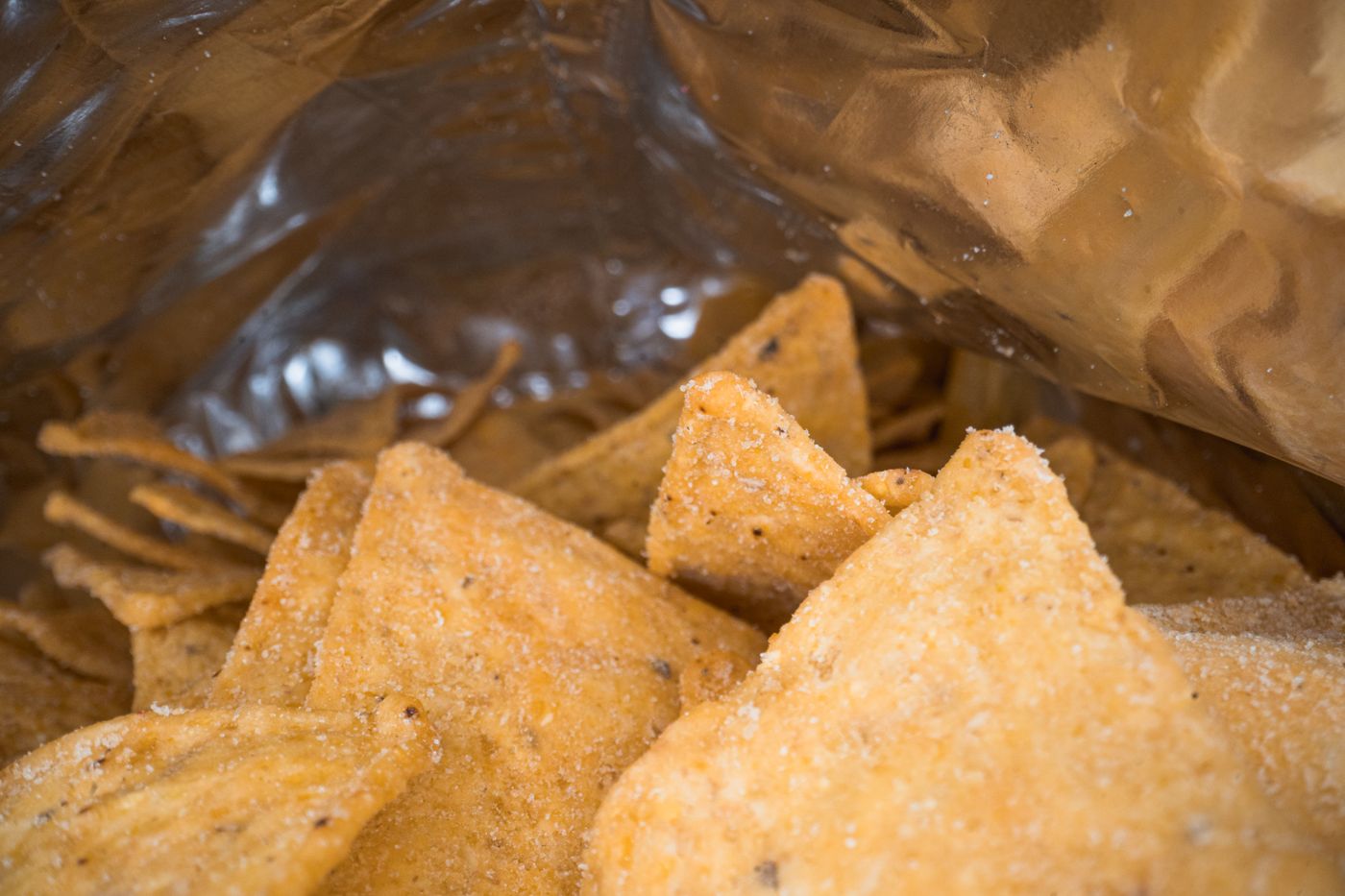 Tortilla chips in an open snack bag