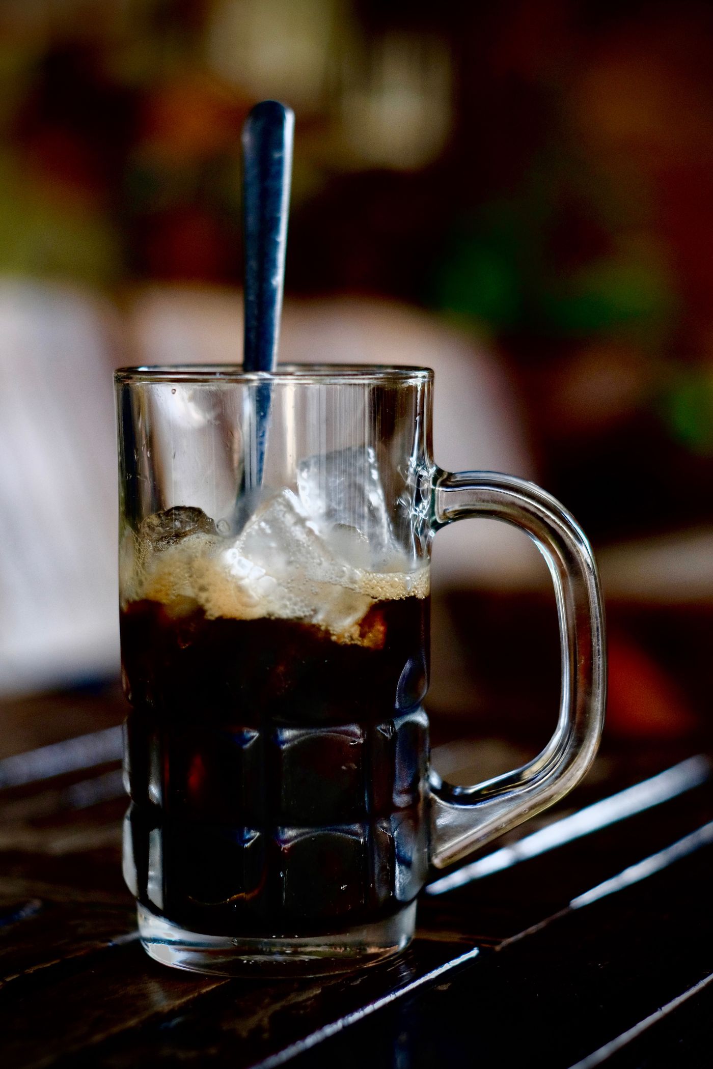 A glass mug filled with iced coffee