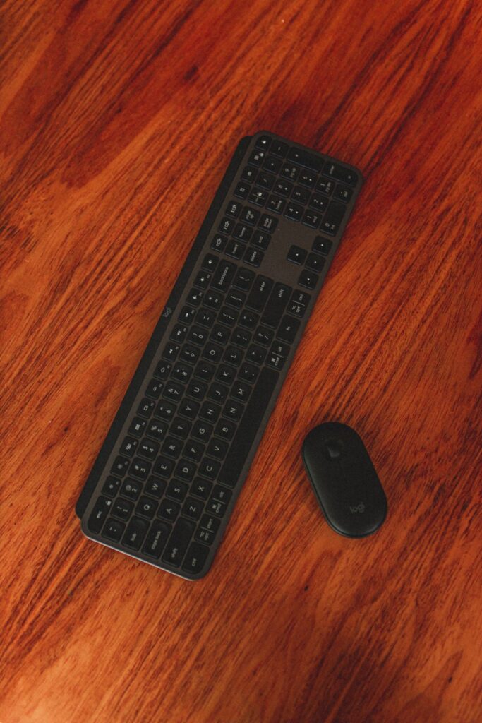 Wireless keyboard and mouse on a wooden desk