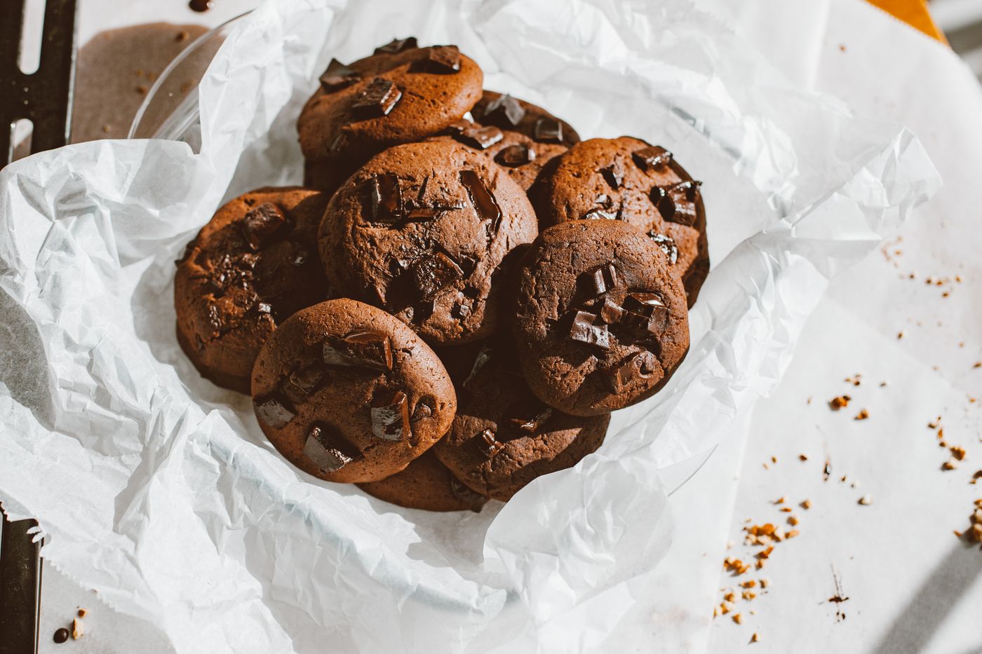 Chocolate chip cookies resting on baking paper
