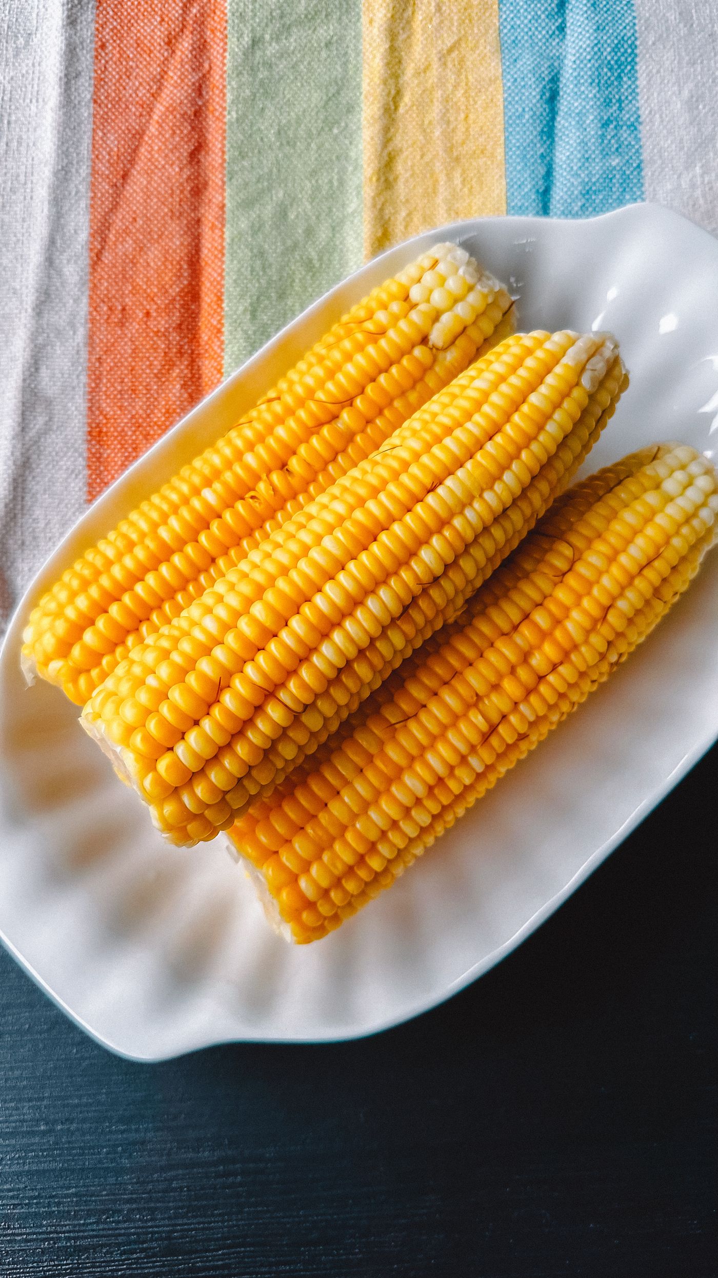 Corn cobs on a white plate