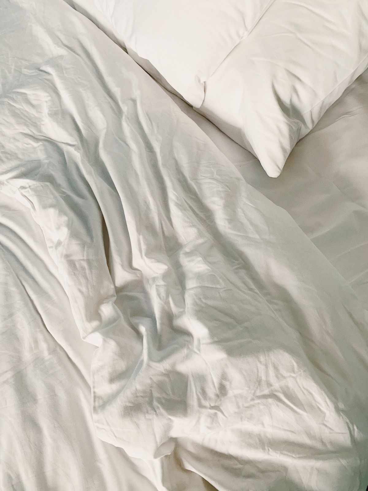 Close view of white bedding and a pillow