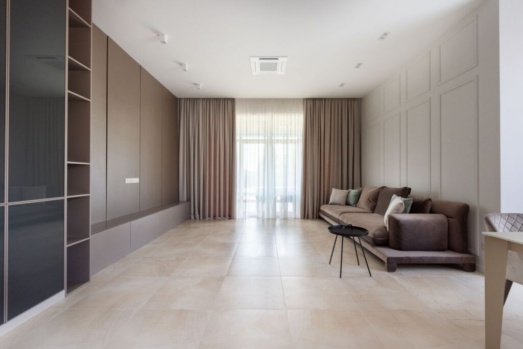 Living room with sofa, shelves and window curtains