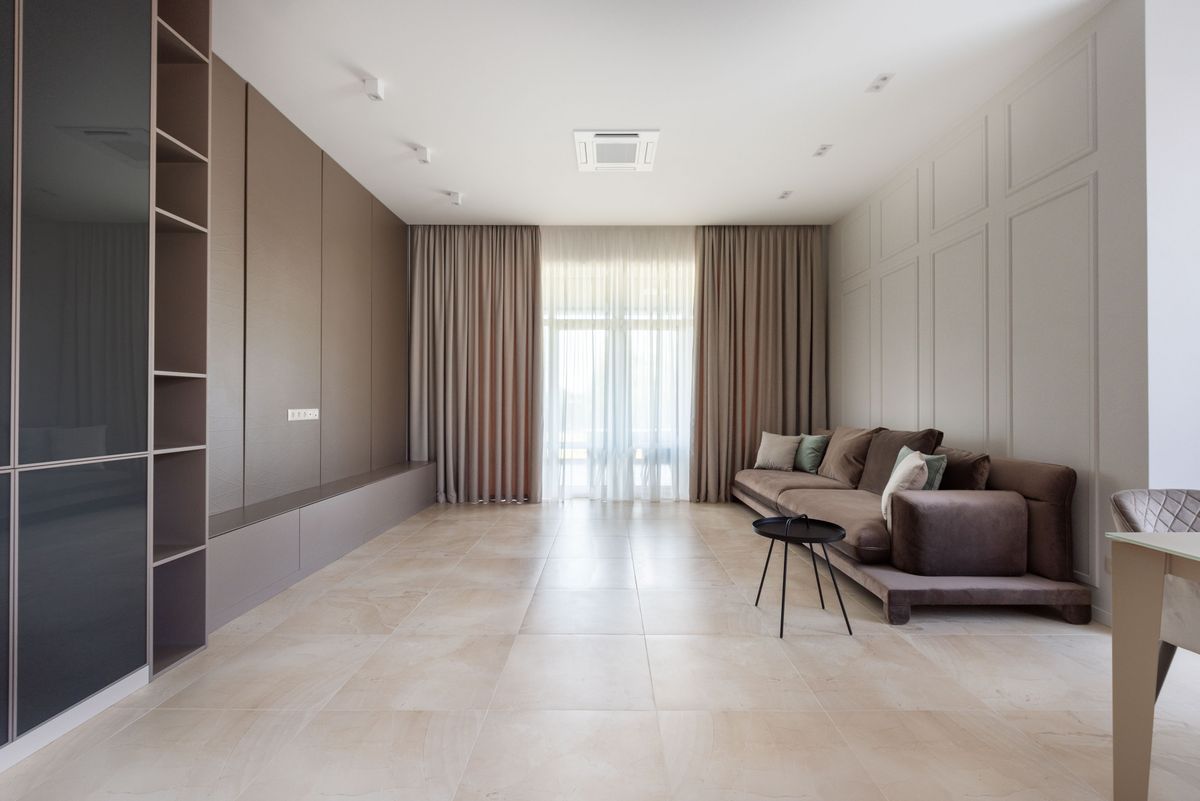 Living room with sofa, shelves and window curtains