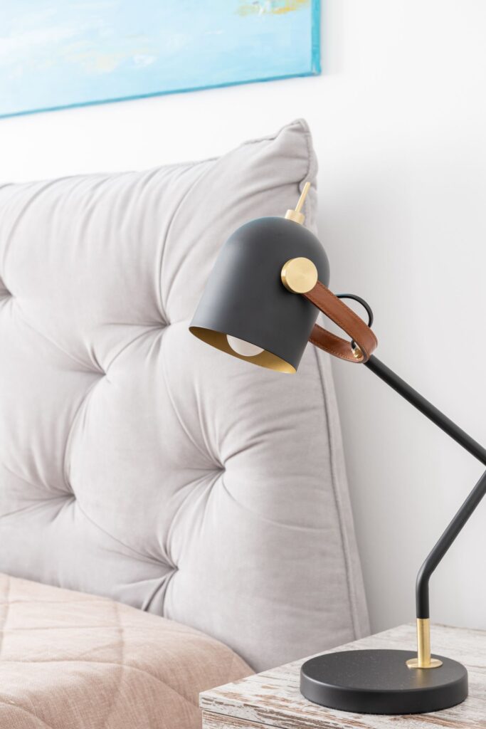 Lamp and bedside table beside a bed