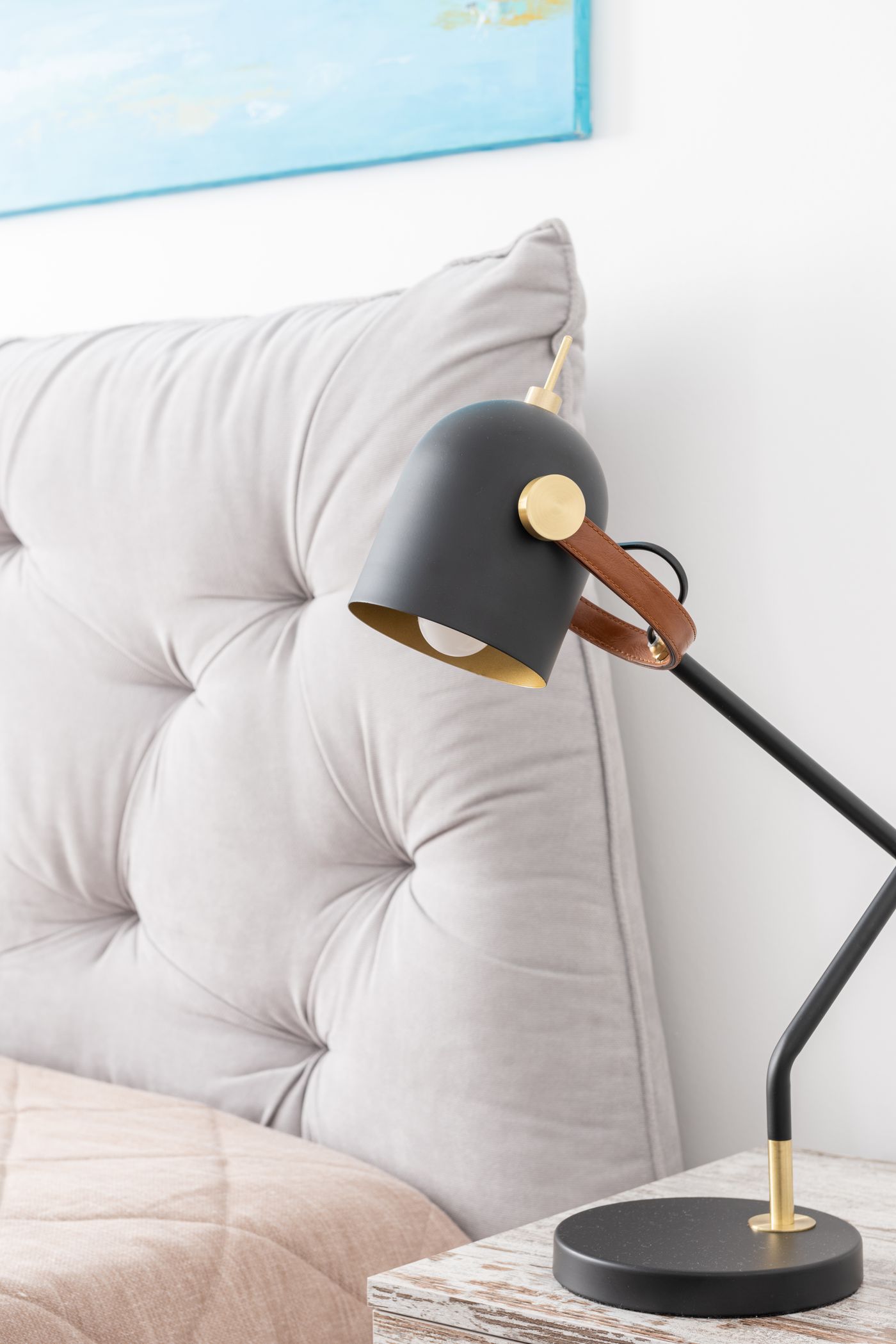 Lamp and bedside table beside a bed