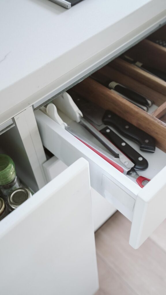 Cooking utensils arranged in a divided kitchen drawer