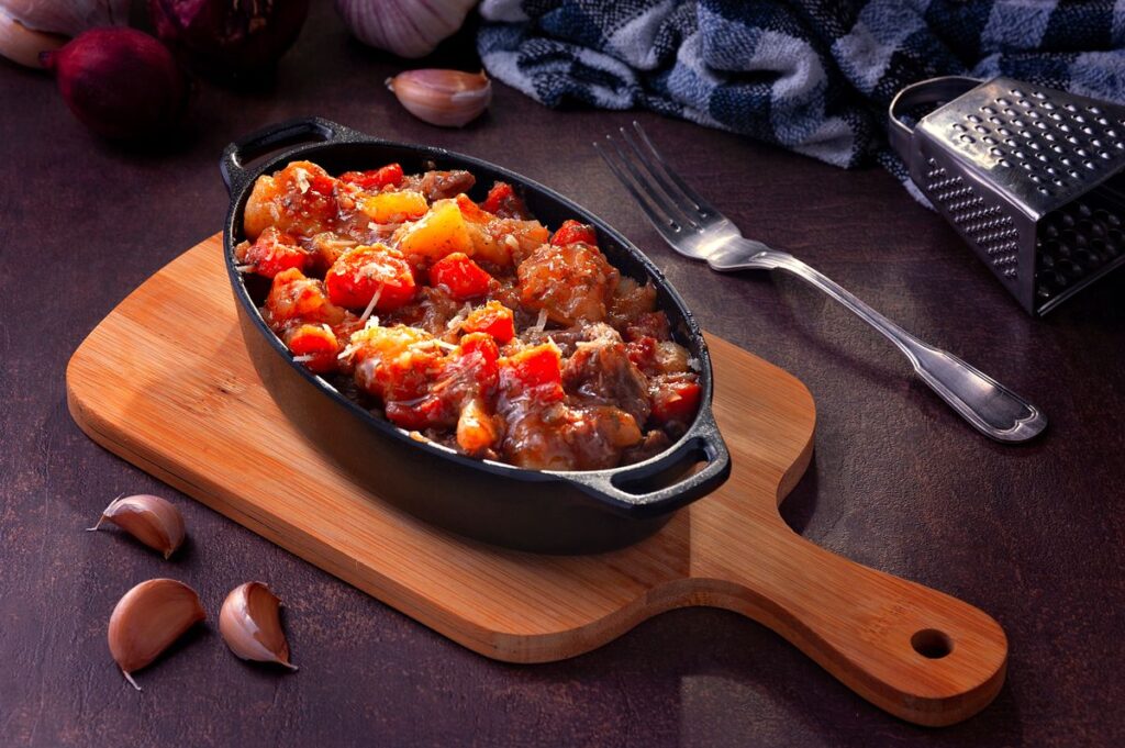 Hearty cooked meal served in a pot on a tray