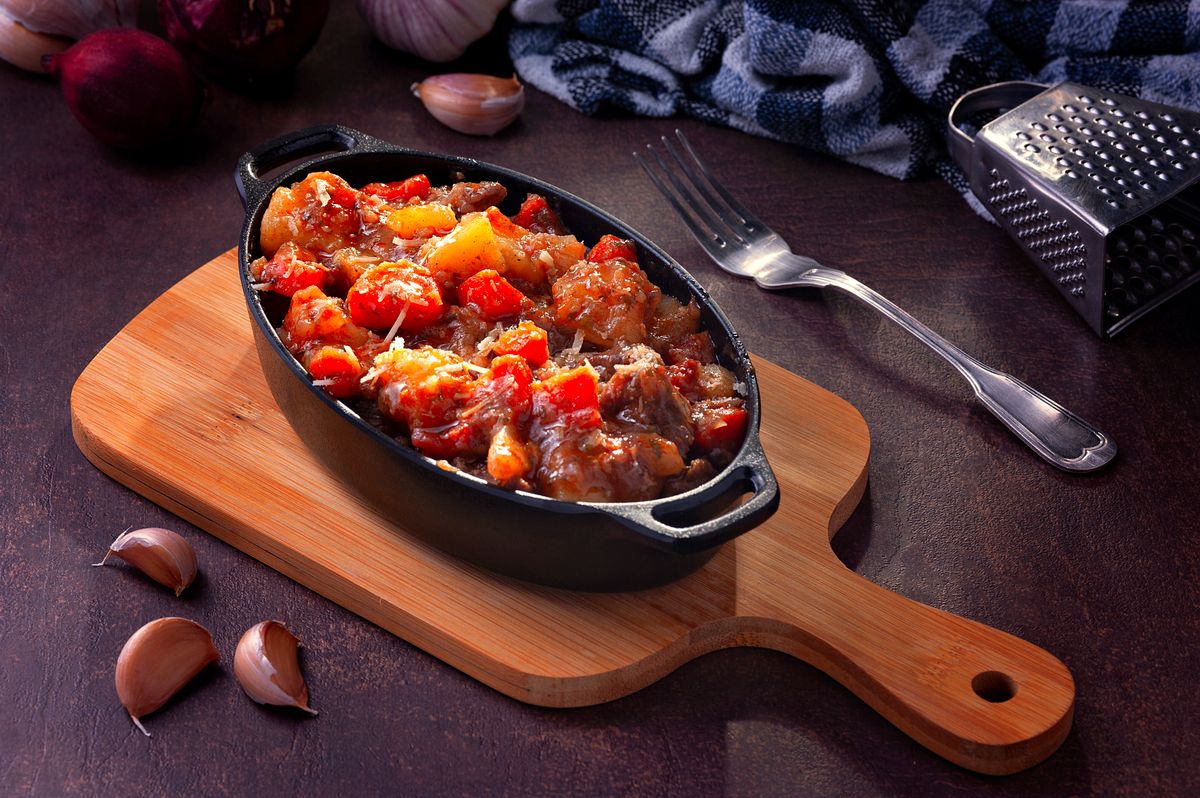 Hearty cooked meal served in a pot on a tray