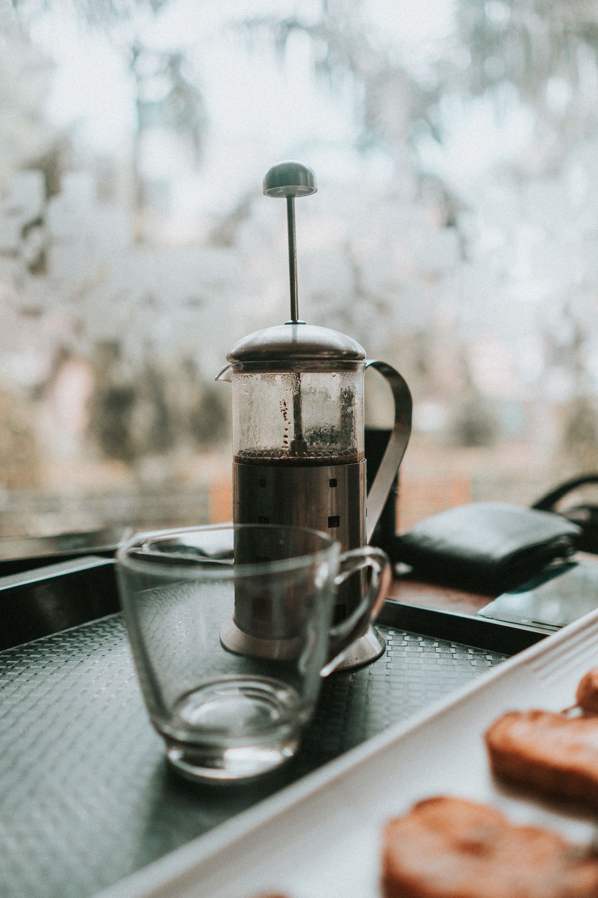 French press beside a glass cup