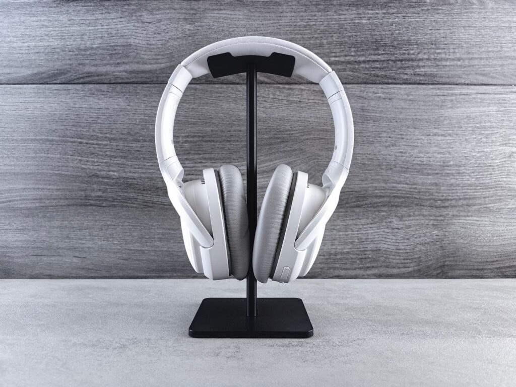 White headphones resting on a stand