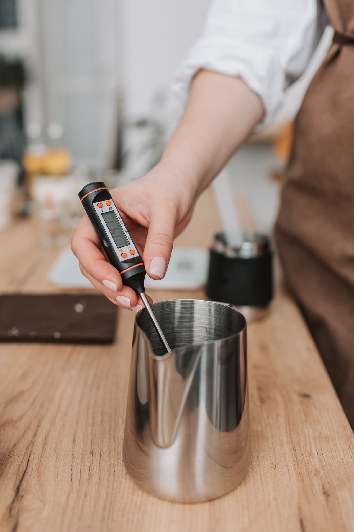 Person using a thermometer in a metal container