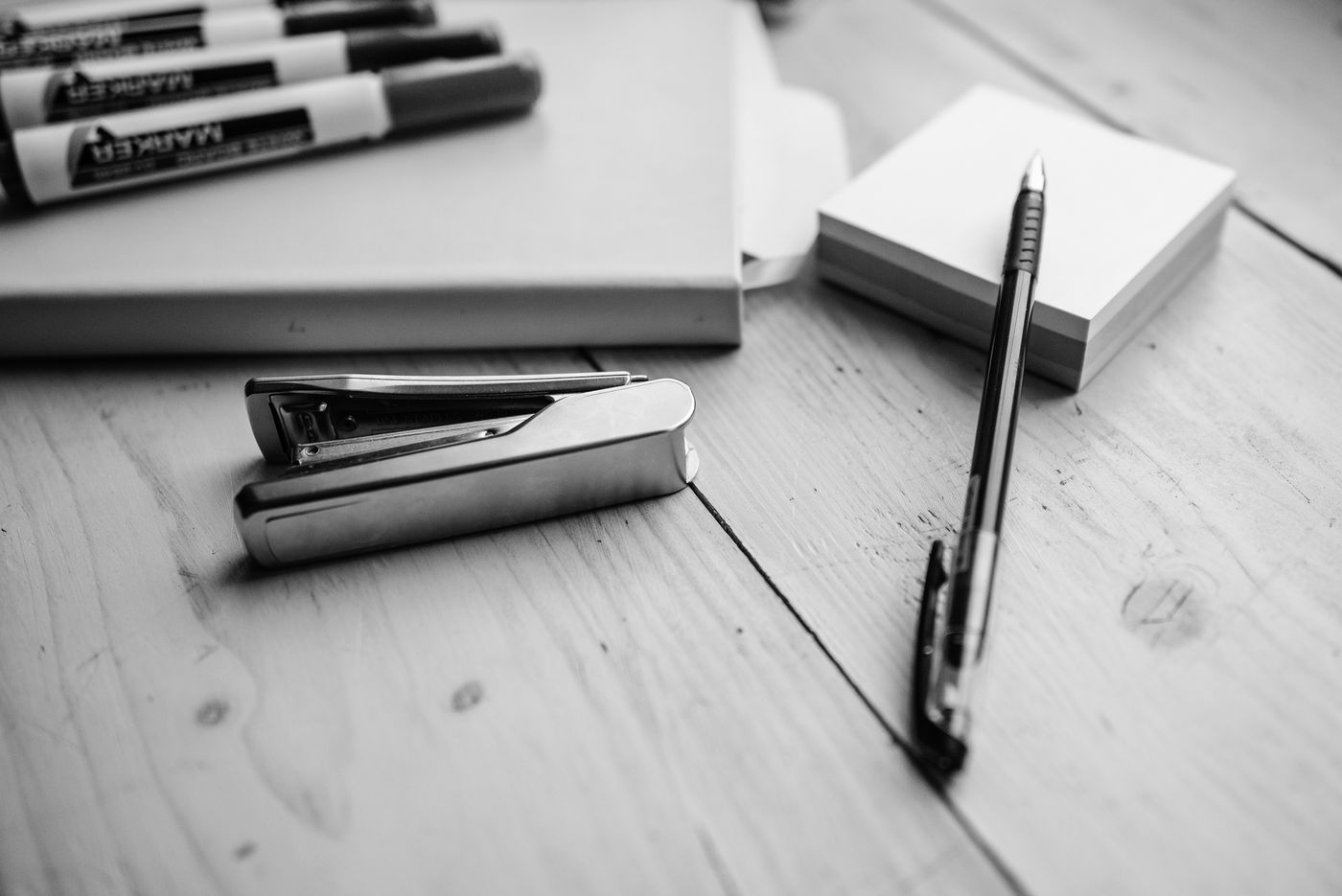 Stapler and pens on a desk