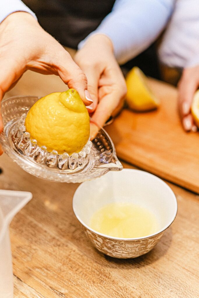 Lemon juice being squeezed during kitchen preparation