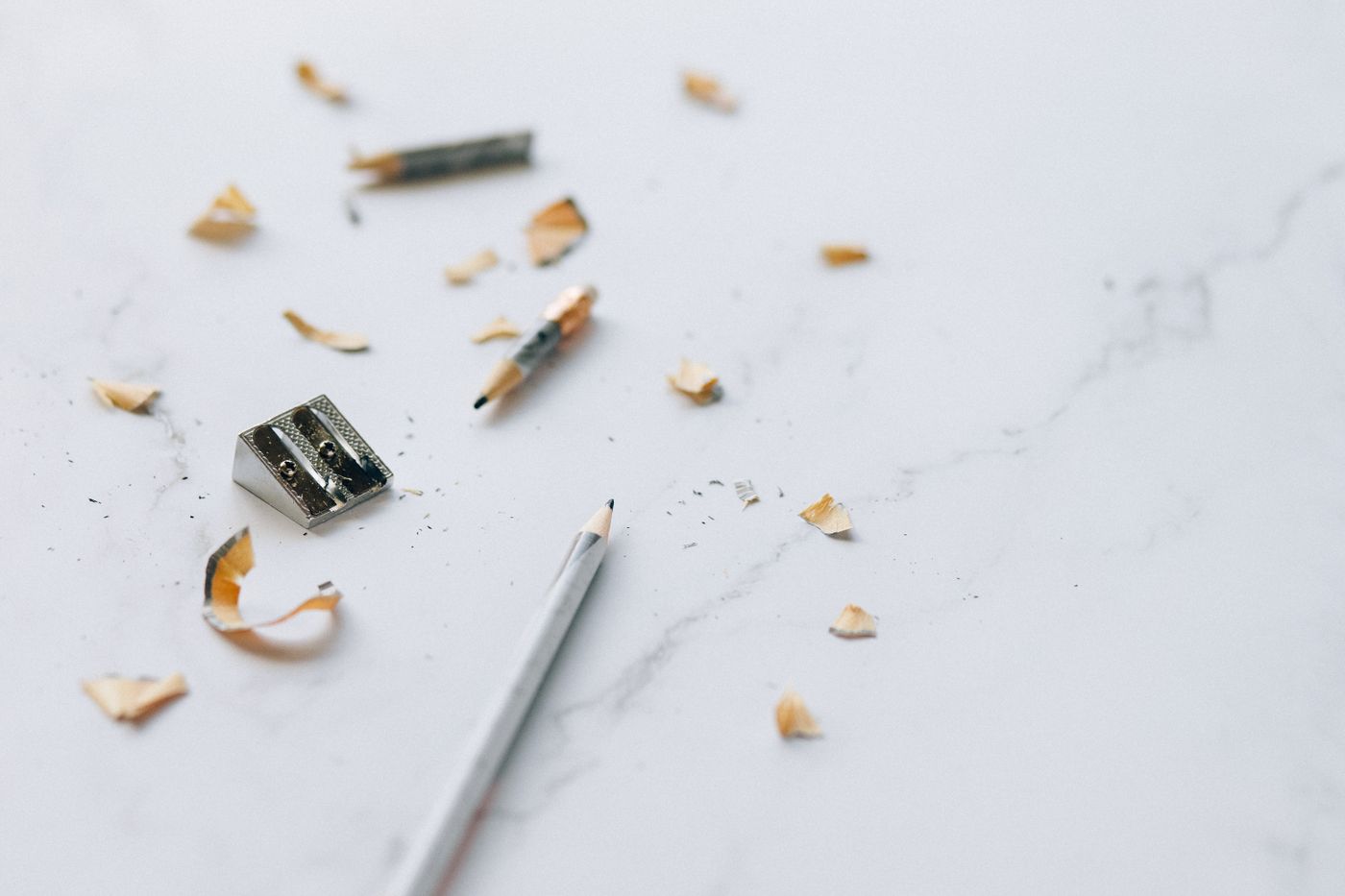 Pencil, sharpener and shavings on a light surface