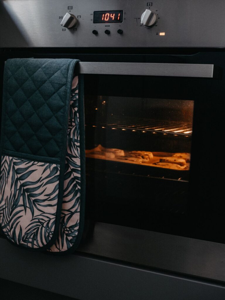 Kitchen oven with a mitt hanging from the handle