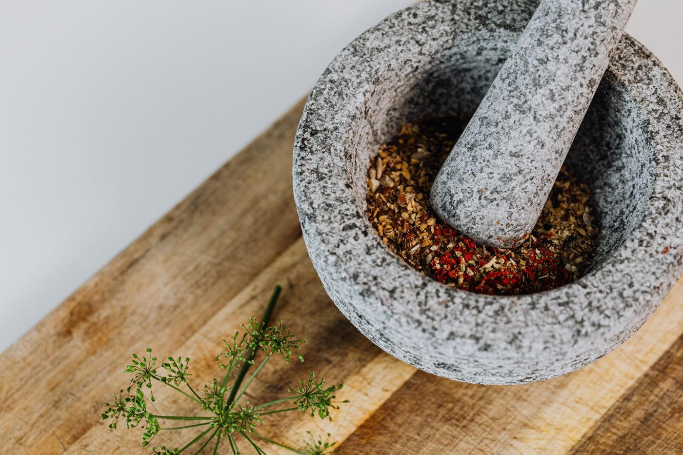Spices in a mortar beside a pestle