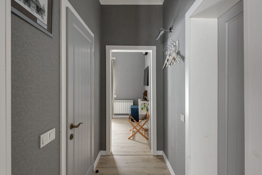 Home hallway with grey walls and wooden doors