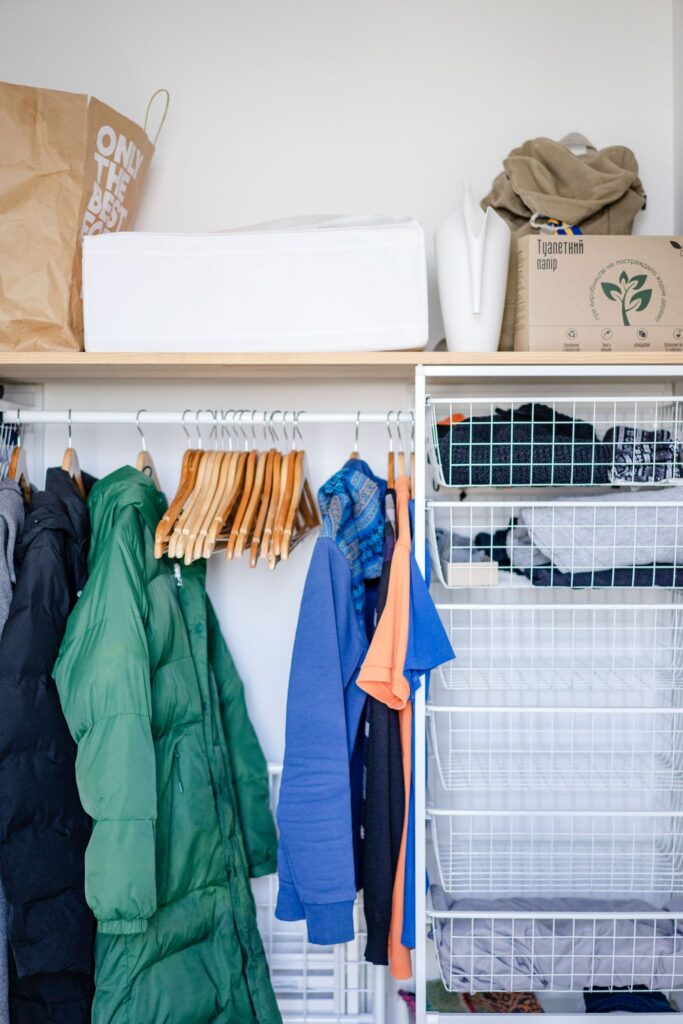 Clothes on hangers inside a wardrobe