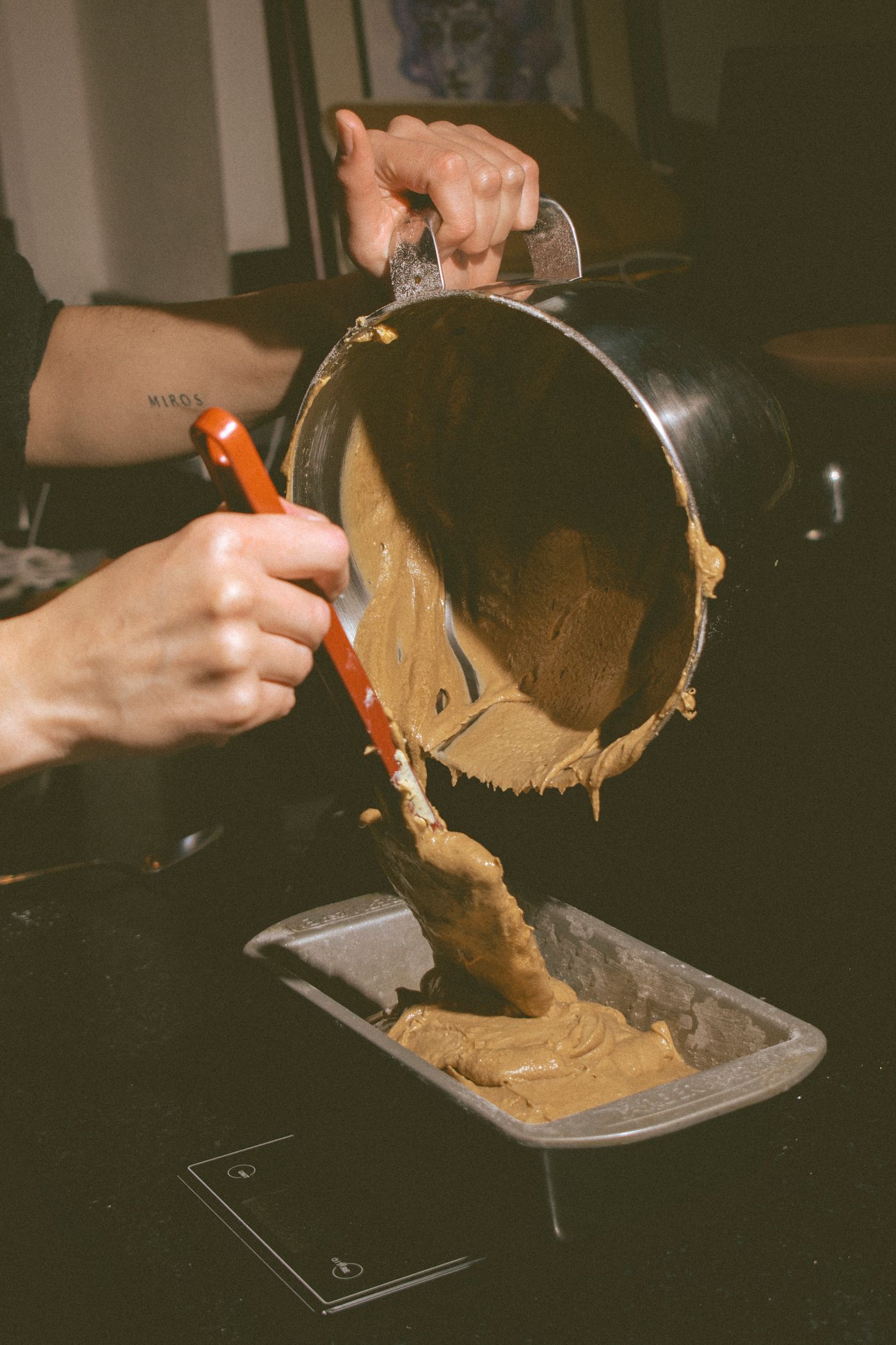 Batter being poured into a loaf pan