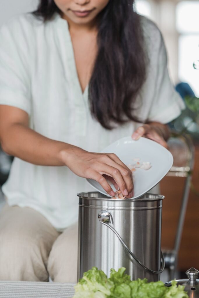 Food scraps being placed in a kitchen collection bucket