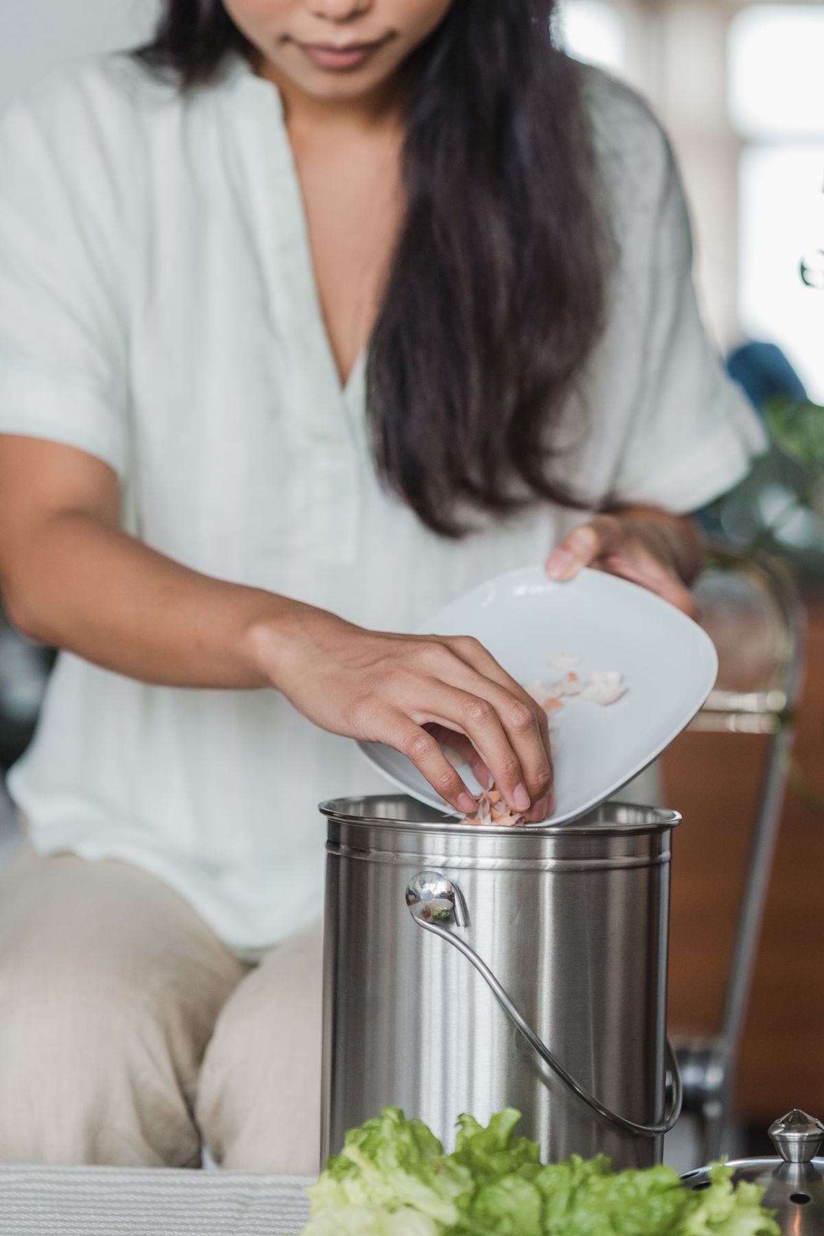 Food scraps being placed in a kitchen collection bucket
