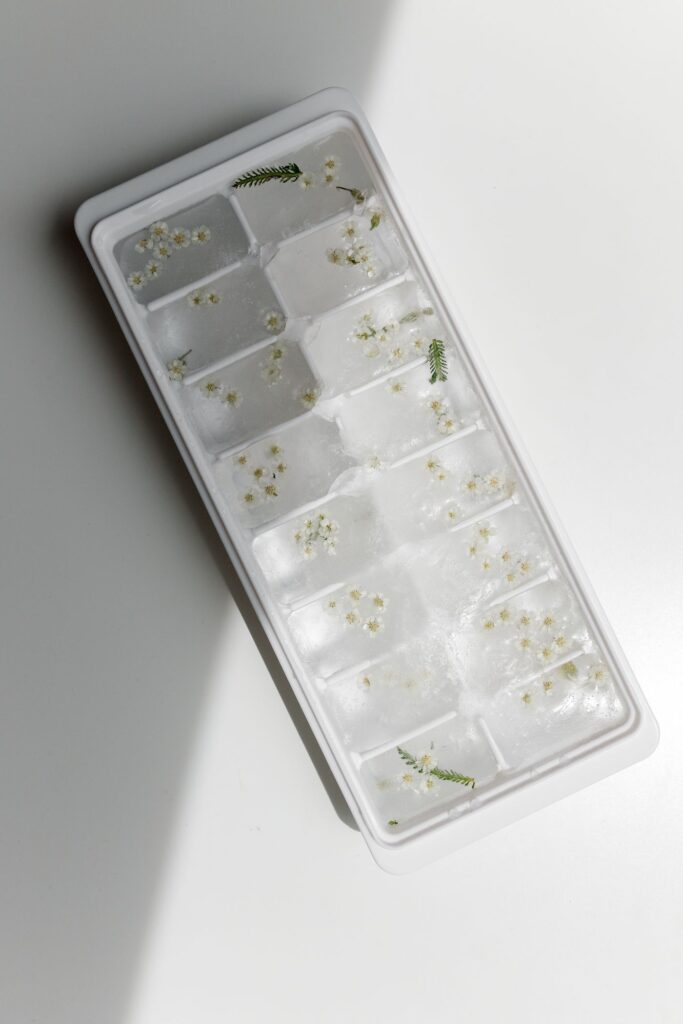 Ice molds with cubes containing small flowers