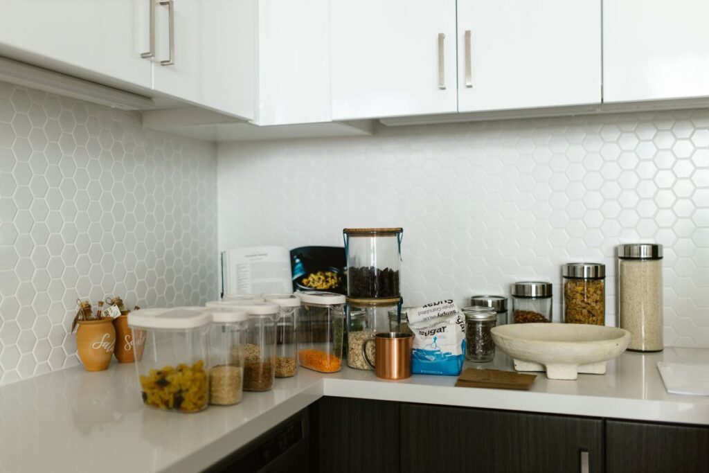 Food containers and glass jars on a kitchen counter
