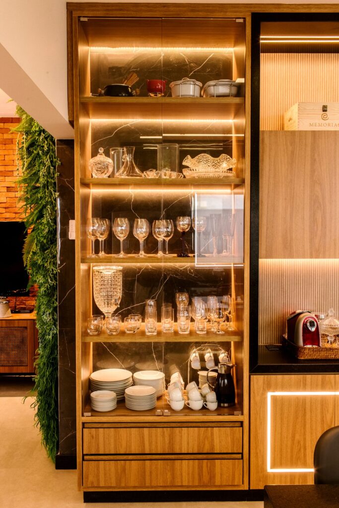 Illuminated kitchen cabinet containing glassware