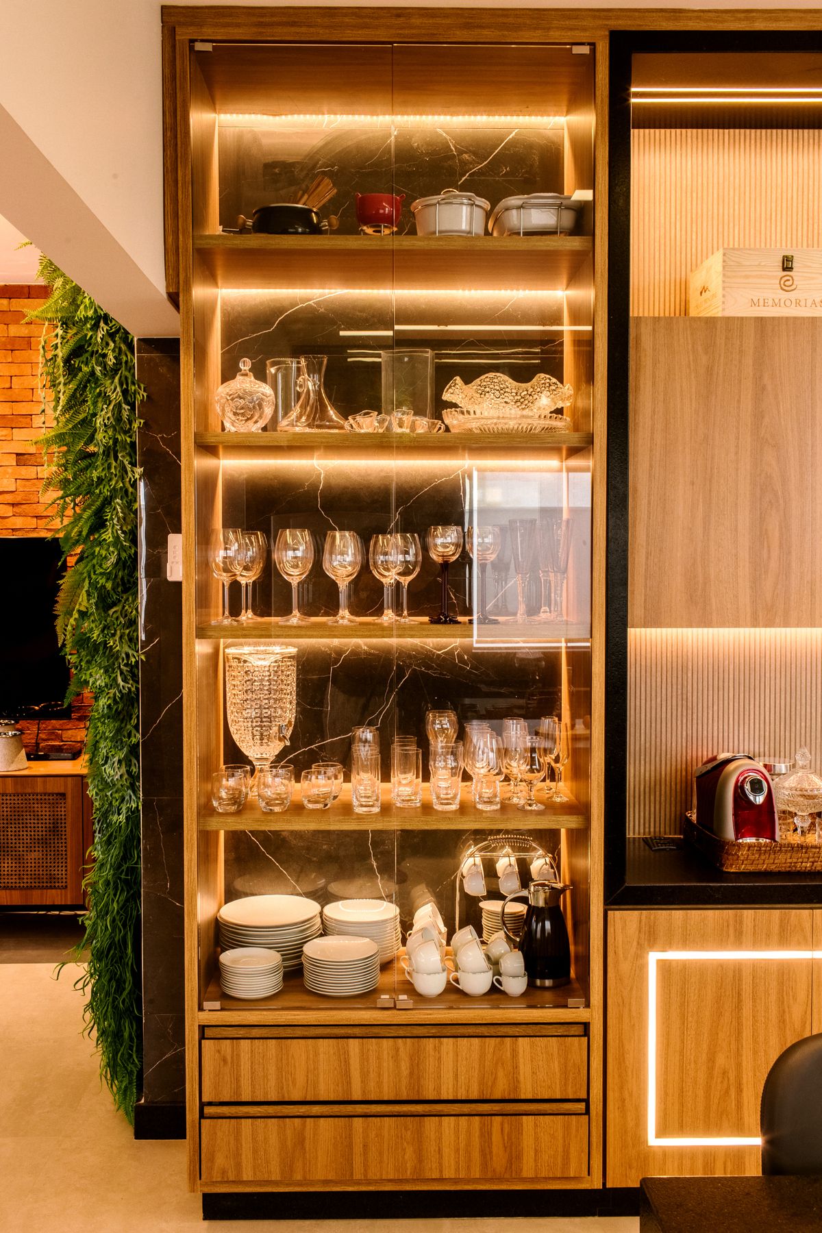 Illuminated kitchen cabinet containing glassware