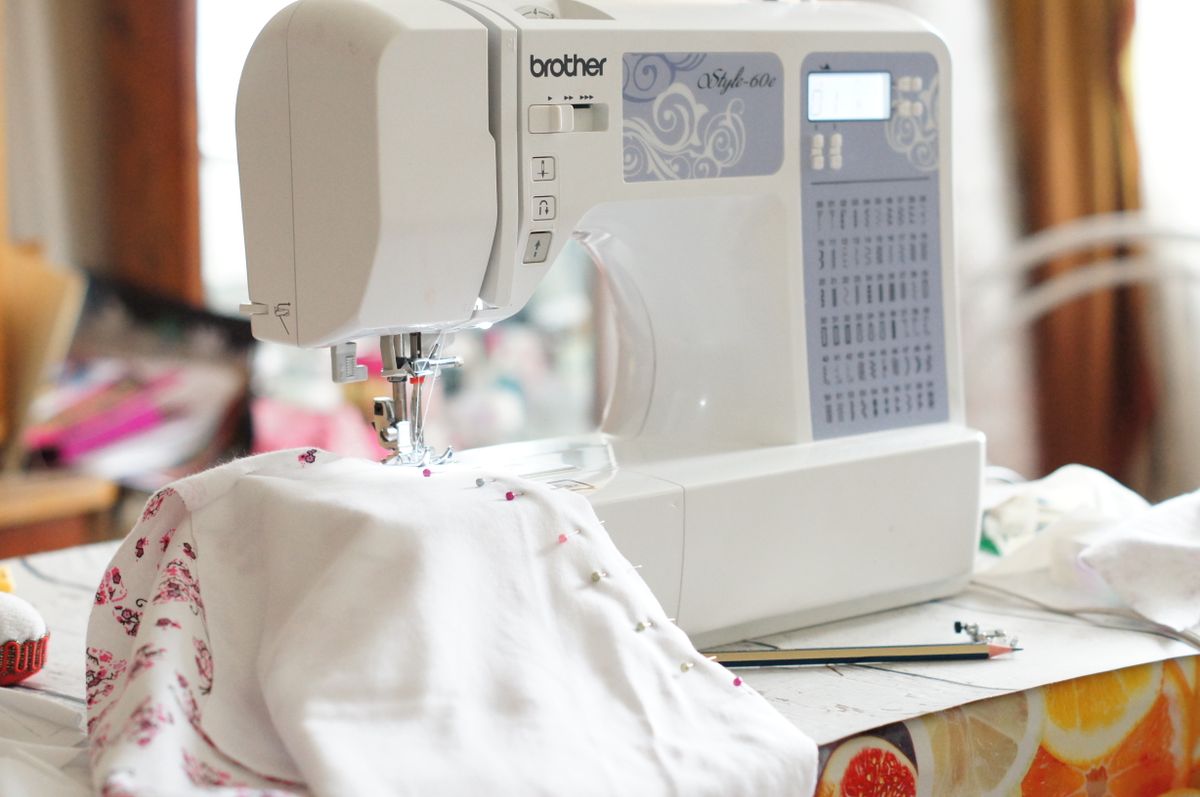 Sewing machine with fabric and pins on a work table