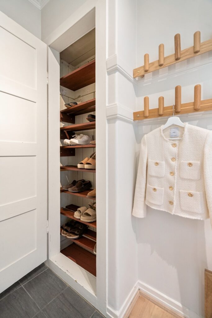 Organized shoe storage beside a clothing area