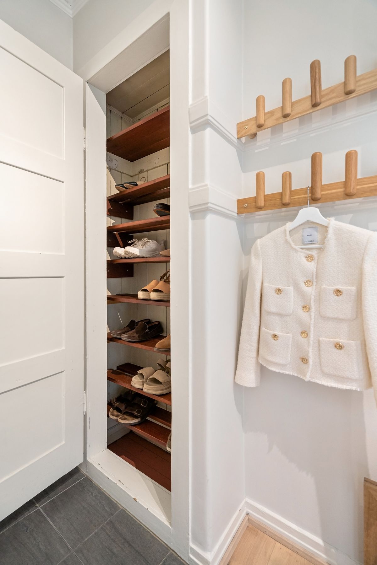 Organized shoe storage beside a clothing area