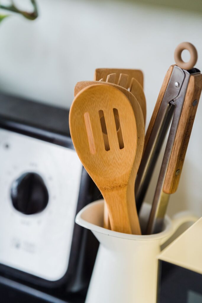 Wooden and metal utensils in a kitchen container