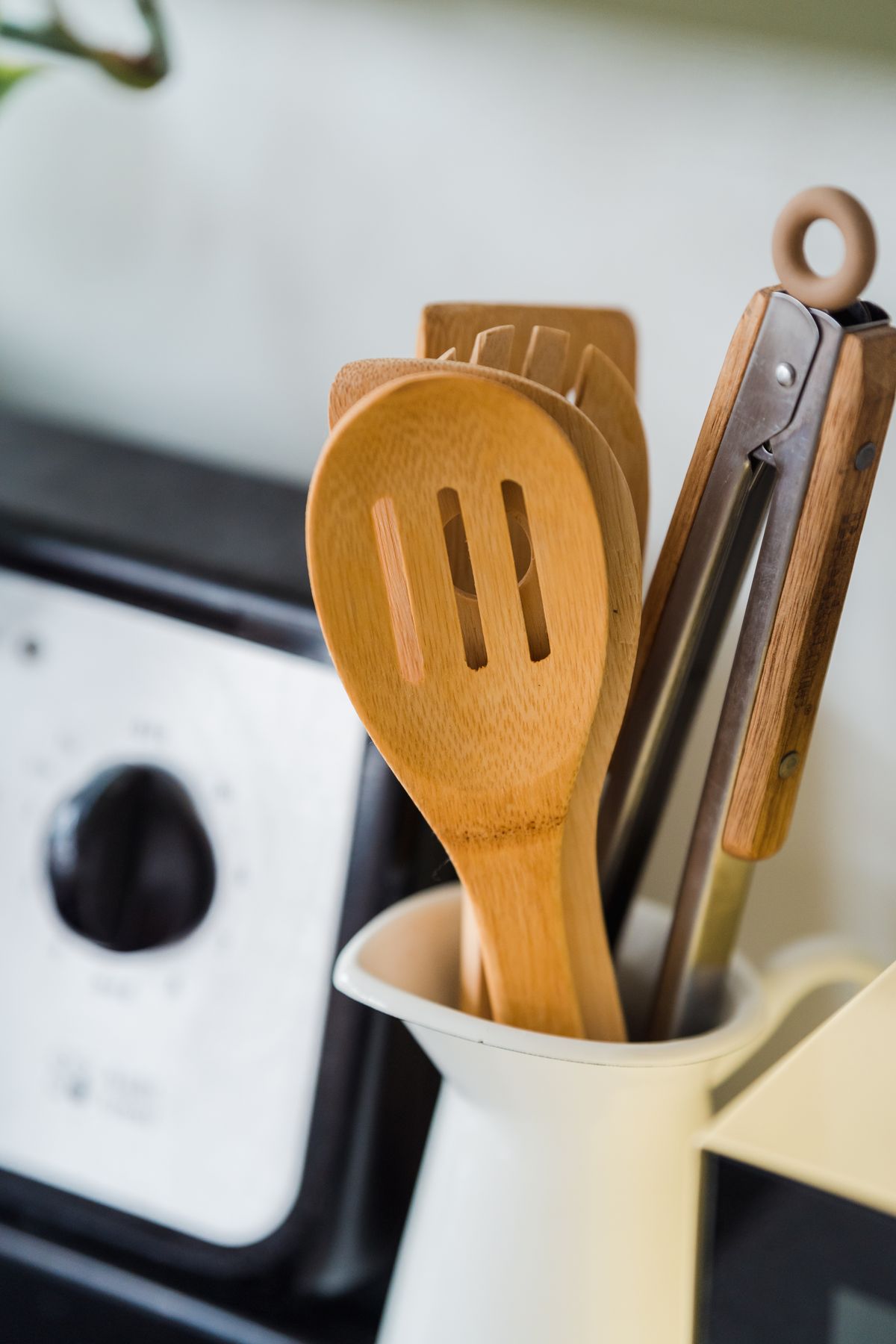 Wooden and metal utensils in a kitchen container