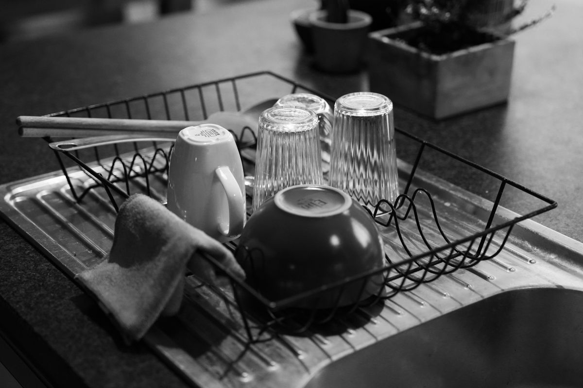 Dish rack holding glassware and dishes