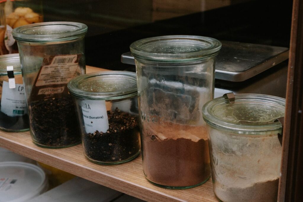 Spice jars arranged on a kitchen shelf