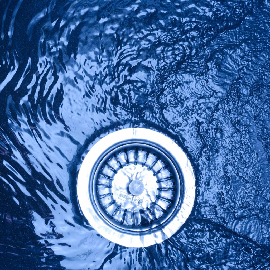 Water near a metal sink drain strainer