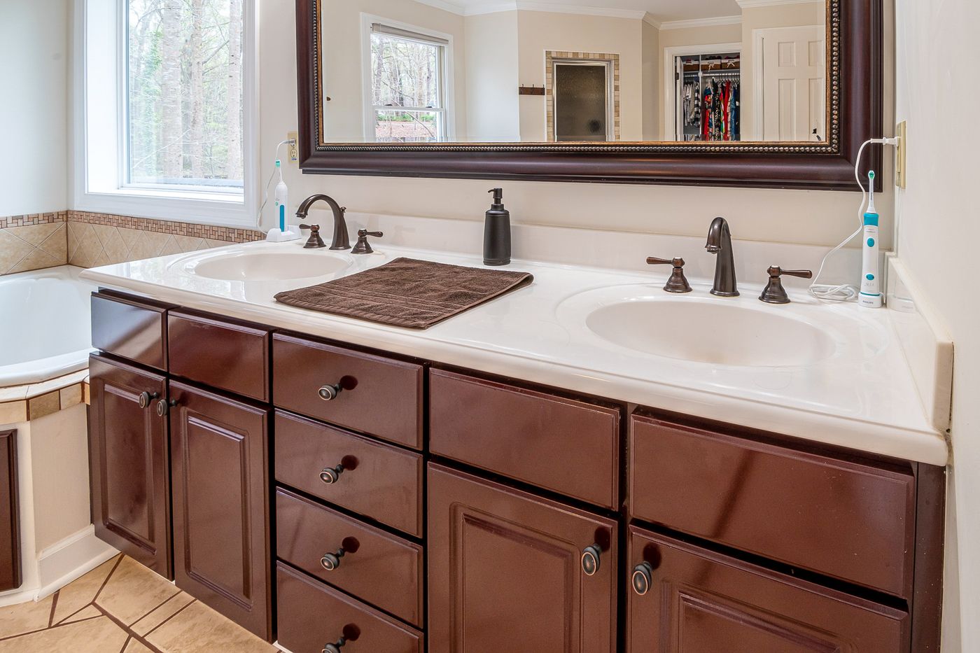 Bathroom sink and countertop with a folded towel and soap dispenser