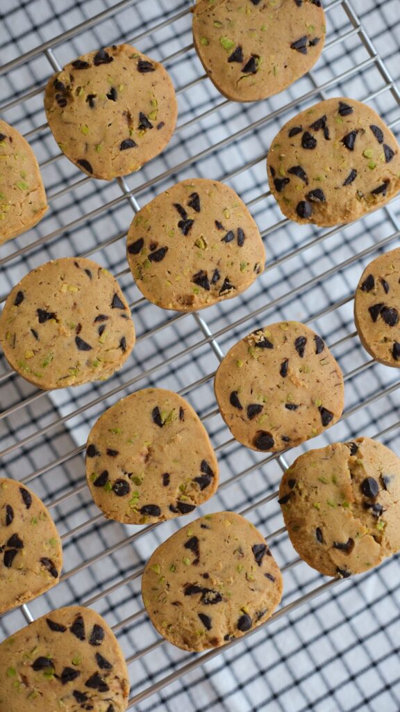 Chocolate chip cookies resting on a cooling rack