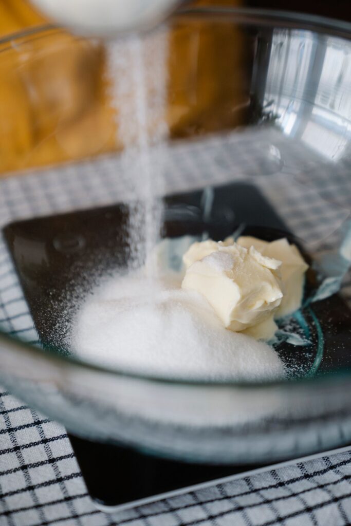 Butter and sugar in a glass mixing bowl