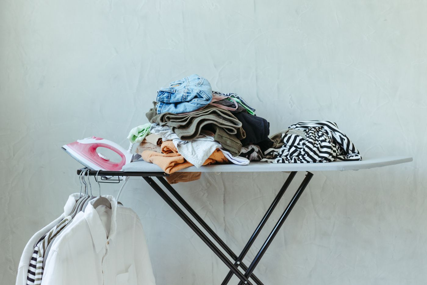 Ironing board with clothes and an iron