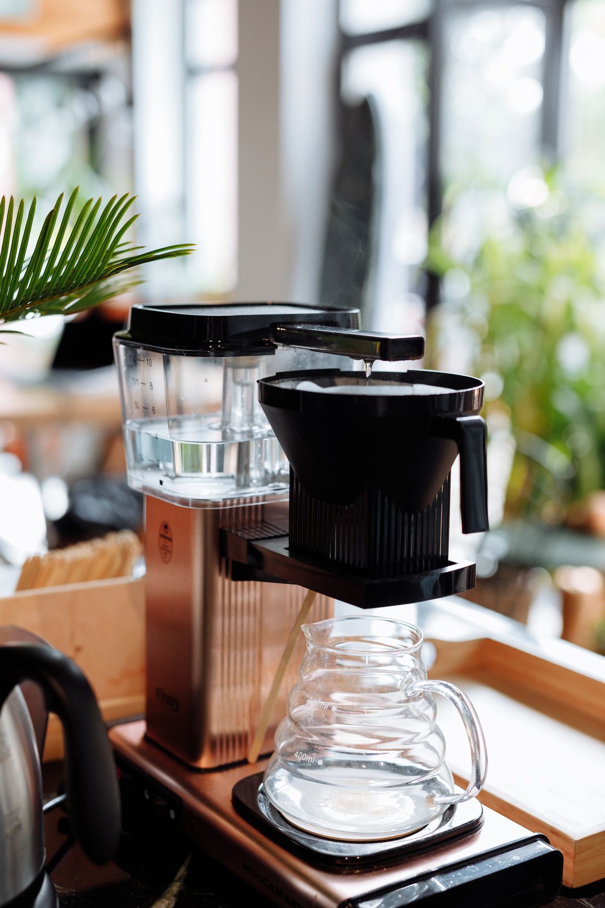 Coffee brewer with a glass carafe on a table