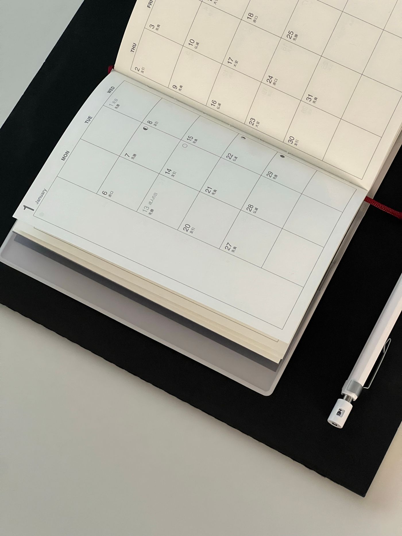 Calendar and notebook arranged on a desk