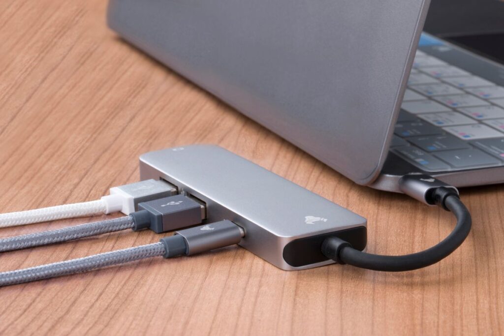 USB hub connected to a laptop on a wooden desk